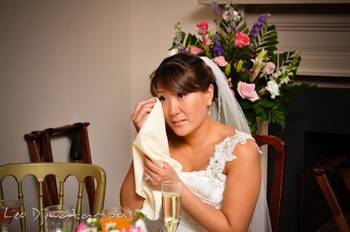 Bride wiping of her tears while watching her groom doing mother and son dance. Ceresville Mansion Frederick Maryland Wedding Photo by wedding photographer Leo Dj Photography